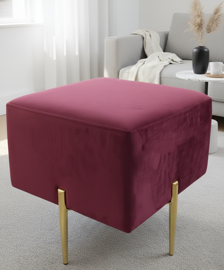 Burgundy velvet square ottoman with gold metal legs.