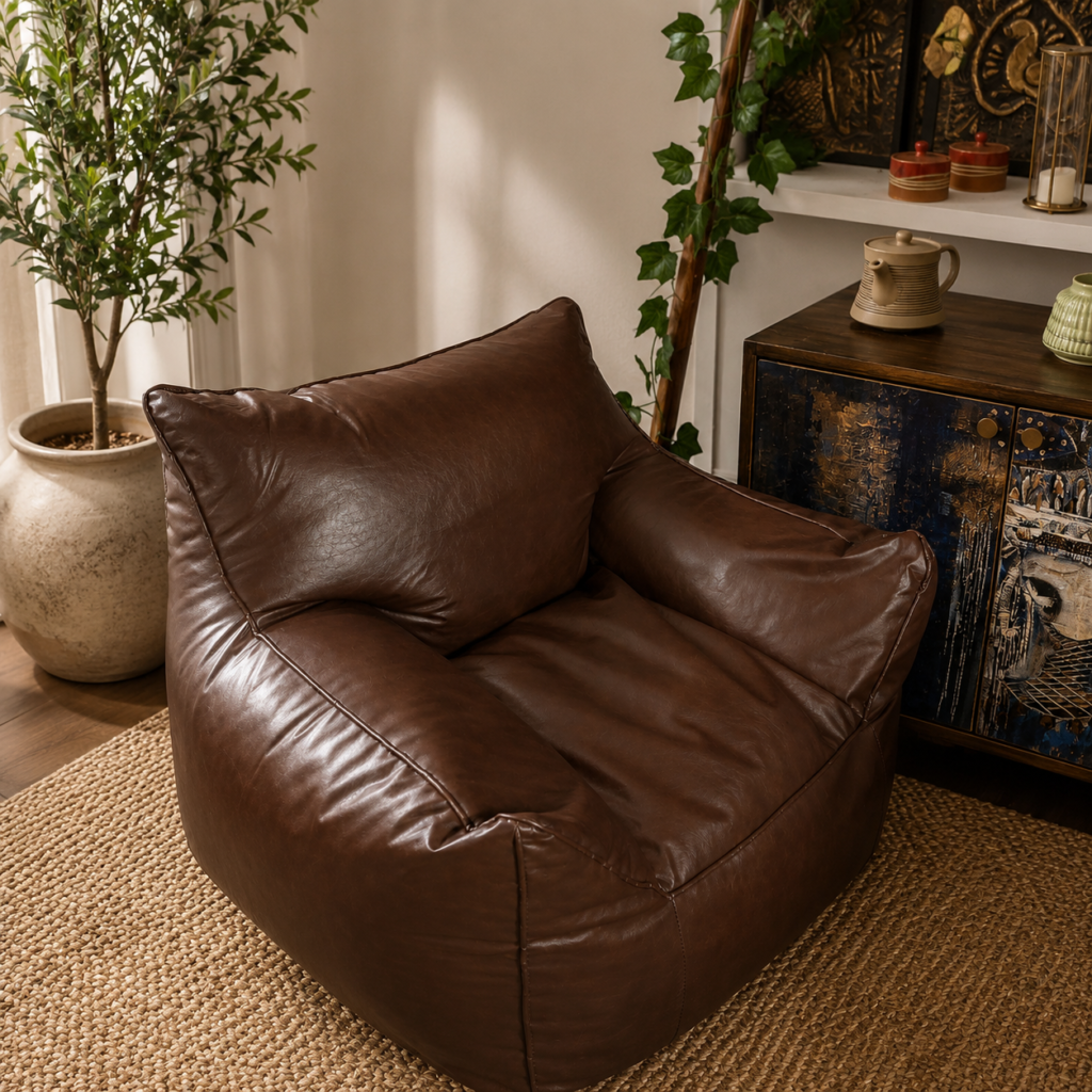 Brown leather lounge chair with soft cushioned seat and arms in a warm modern living room.