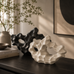Abstract ceramic showpiece in black and white color options on a modern console table.