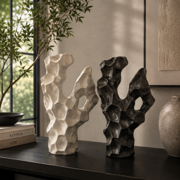 Abstract ceramic sculpture décor in black and white color options on a modern console table.