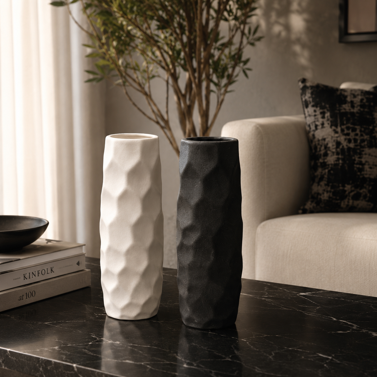 vase 1 Black and white textured ceramic vase set on a marble coffee table in a modern living room.