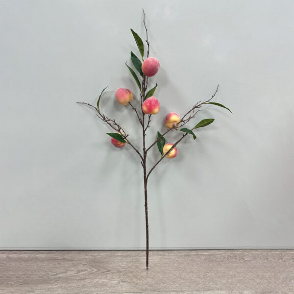 Artificial peach branch with realistic pink and yellow peach fruits, green leaves, and natural brown branches for decorative vase arrangements and modern home décor.