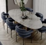 Odessa marble oval dining table, top-down view styled with dried branch centerpiece