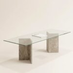 Vitra glass dining table with raw travertine legs, angled view