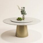 Marbella round marble dining table with brushed brass pedestal base, front angle view