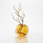 Faceta amber glass vase with sculptural branch, faceted geometric form