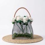Marlo glass handbag vase with leather handle, styled with crochet floral arrangement
