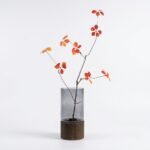Alder smoked glass cylinder vase with wood base, styled with branch arrangement
