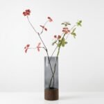 Alder smoked glass cylinder vase with wood base, styled with branch arrangement