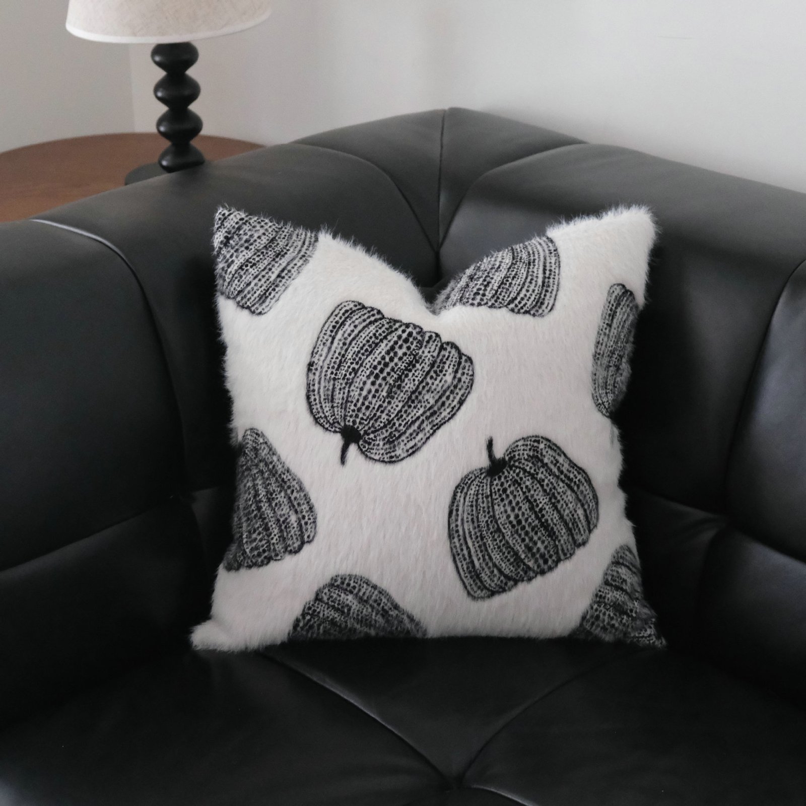 pillow 11 Maren black pumpkin motif cushion with white pumpkins on black leather sofa