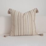 Close-up of raised sand and camel dotted stitches on Dune cushion