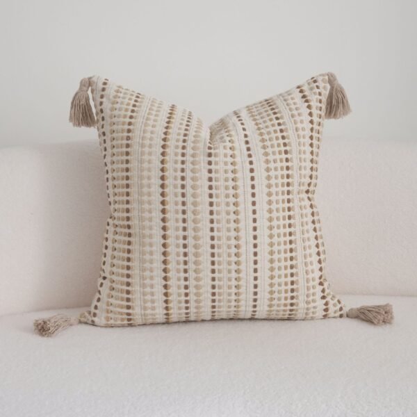 Close-up of raised sand and camel dotted stitches on Dune cushion